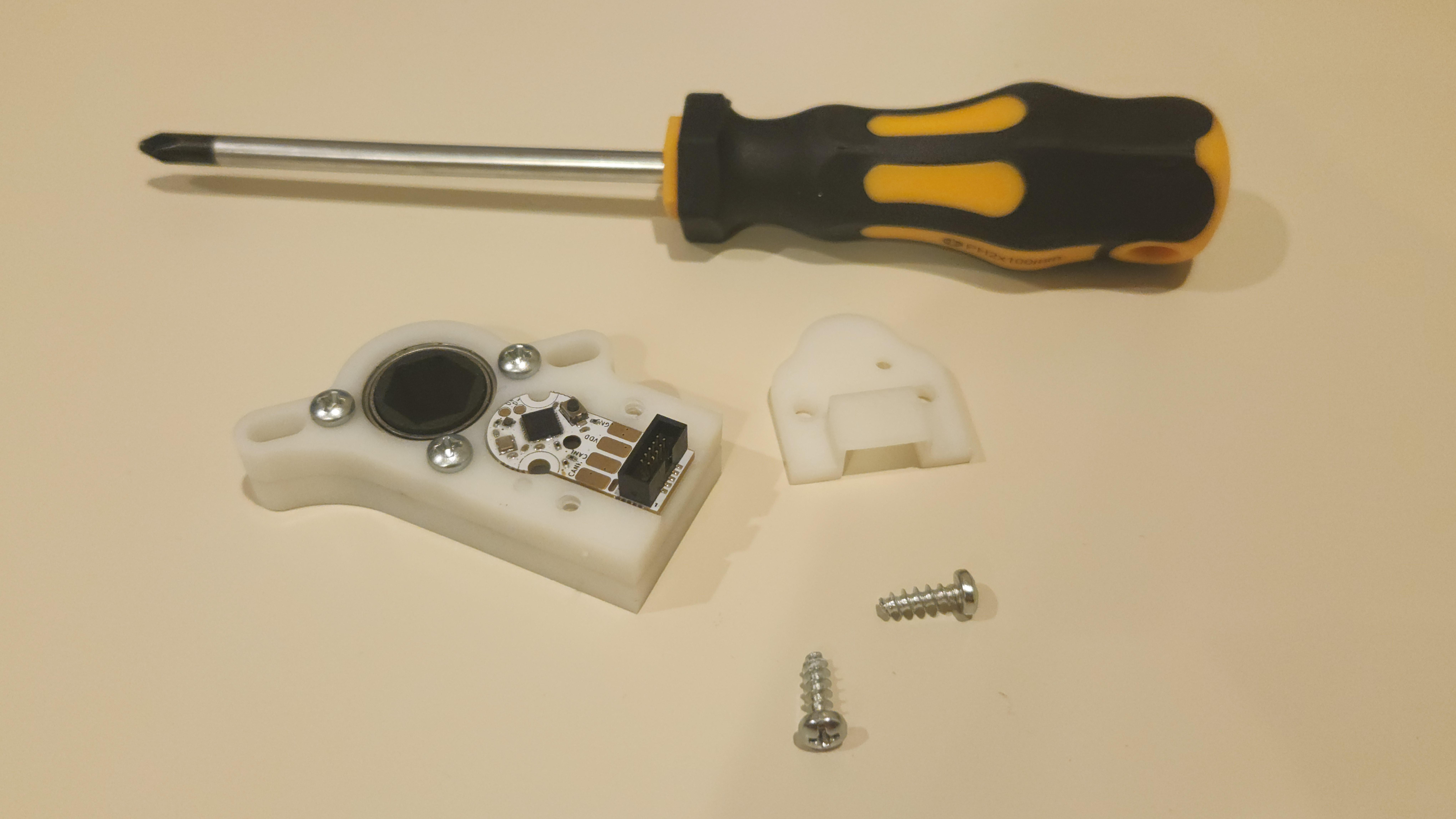 Image showing the various things you need to assemble a throughbore, including the main assembly, cover, and screws